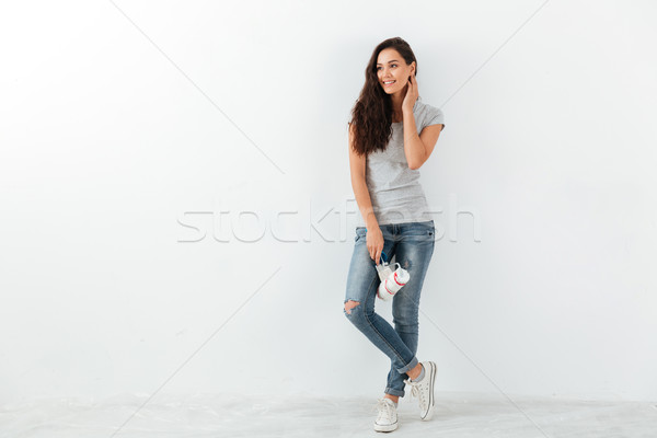 Full length of smiling woman holding brush and paint roller Stock photo © deandrobot