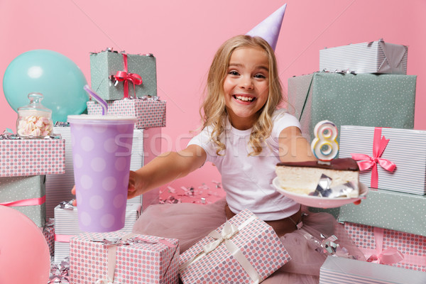 Portrait of an excited little girl in a birthday hat Stock photo © deandrobot