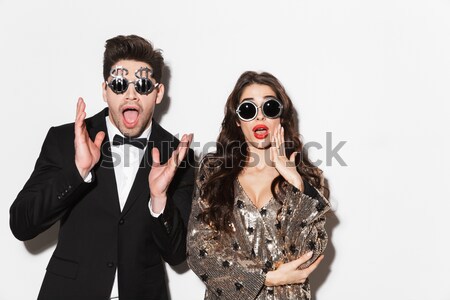 Playful surprised punk couple posing with fake eyeglasses and lips Stock photo © deandrobot