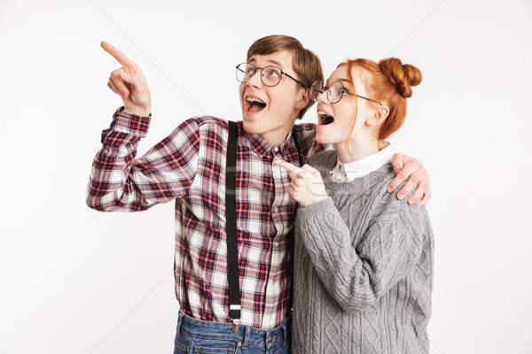 Cheerful couple of school nerds pointing Stock photo © deandrobot
