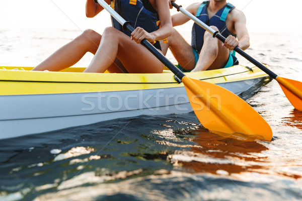 Cropped image of a couple kayaking on lake Stock photo © deandrobot