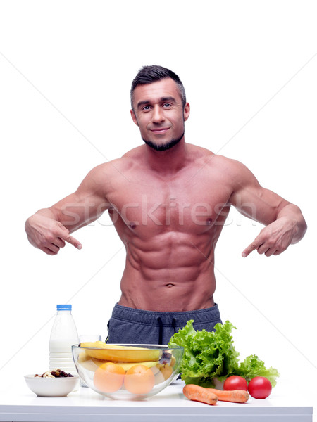 Portrait of a handsome muscular man with healthy food Stock photo © deandrobot