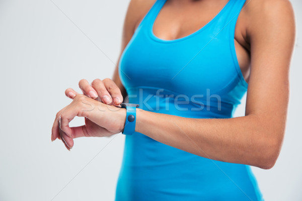 Woman using fitness tracker on wrist Stock photo © deandrobot