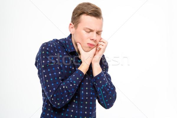 Desperate handsome young male suffering from toothache Stock photo © deandrobot