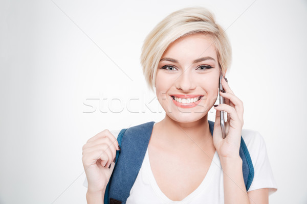 Smiling female student talking on the phone Stock photo © deandrobot