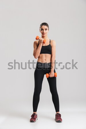 Sportive girl doing squatting holding dumbbells Stock photo © deandrobot