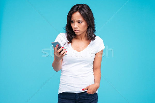 Surprised brunette vietnamese woman talking on the phone Stock photo © deandrobot