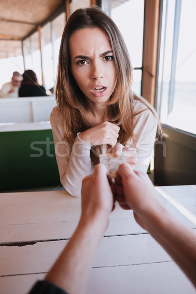 Vertical image of evil woman pulls out credit card Stock photo © deandrobot