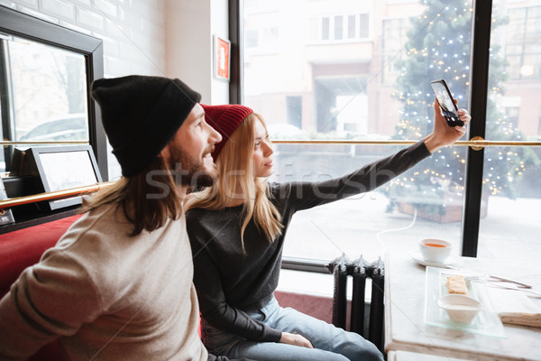 Stock photo: Side view of Young Woman making selfie with boyfriend