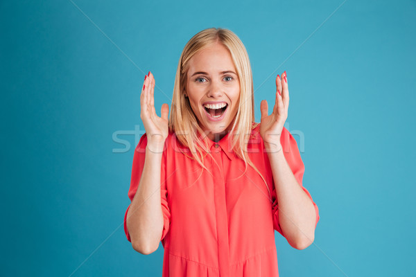 Portré boldog izgatott fiatal nő vörös ruha izolált Stock fotó © deandrobot