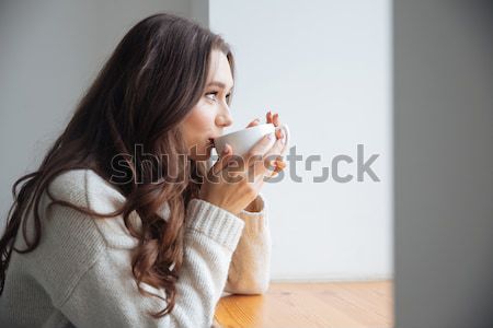 Young woman holding cup of coffee Stock photo © deandrobot