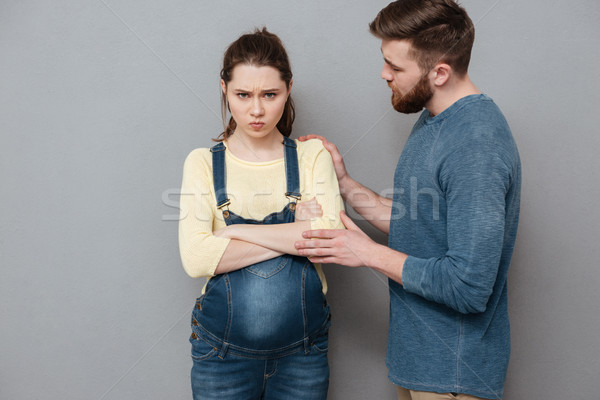 Pregnant angry woman standing near confused man Stock photo © deandrobot