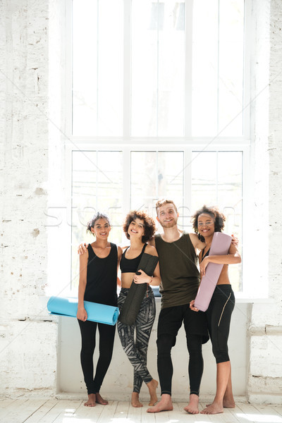 Full-length shot of positive people with training mats Stock photo © deandrobot