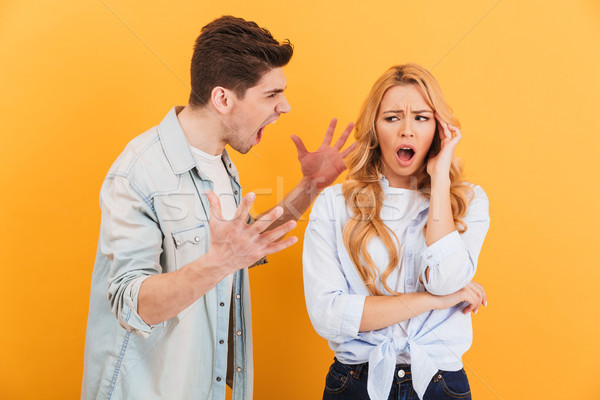 Photo of displeased confused couple fighting while man shouting  Stock photo © deandrobot