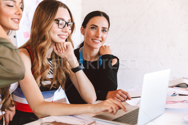 Three pretty young women clothes designers Stock photo © deandrobot