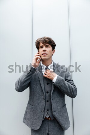 Portrait of a pensive asian man isolated on a white background Stock photo © deandrobot