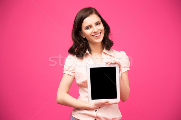 Yougn happy woman showing tablet computer screen Stock photo © deandrobot