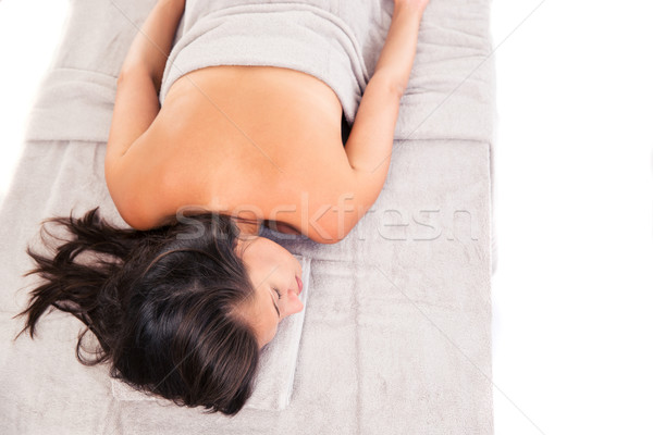 Wman lying on massage lounger Stock photo © deandrobot