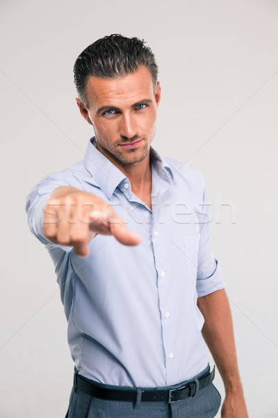 Businessman pointing finger at camera Stock photo © deandrobot