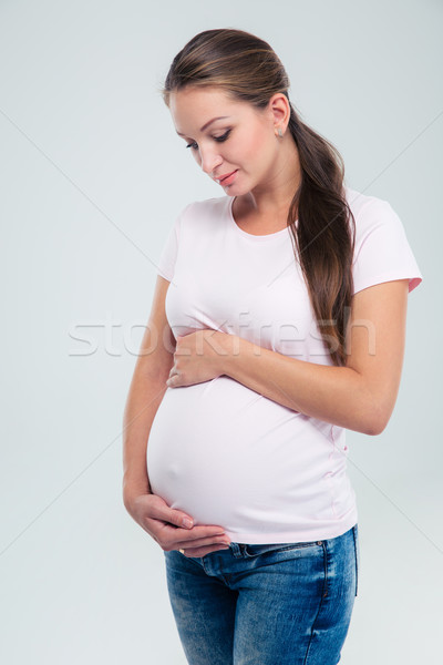 Pregnant woman caressing her belly Stock photo © deandrobot