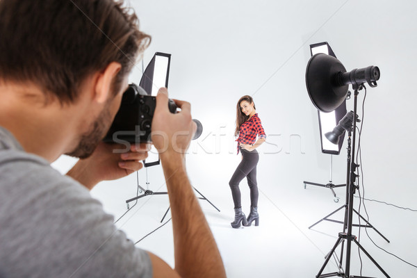 Photographer working with model in studio  Stock photo © deandrobot