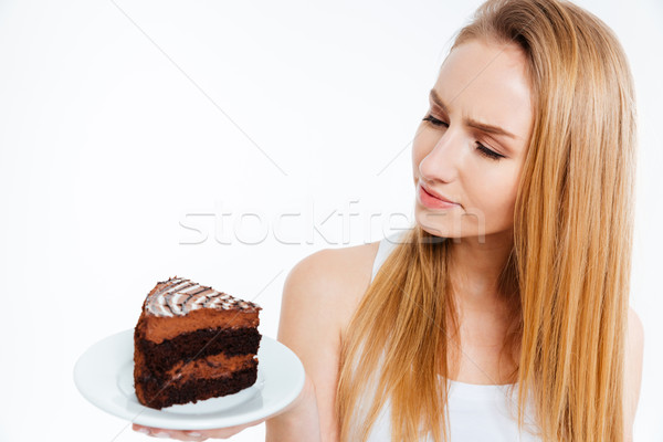 Töprengő gyönyörű nő néz darab csokoládés sütemény gyönyörű Stock fotó © deandrobot