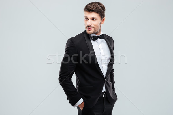 Attractive young man in tuxedo and bowtie Stock photo © deandrobot