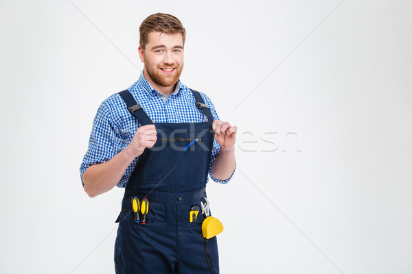 Smiling handsome male builder looking at camera Stock photo © deandrobot