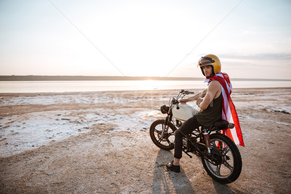 Man in golden in american cape sitting on his motocycle Stock photo © deandrobot