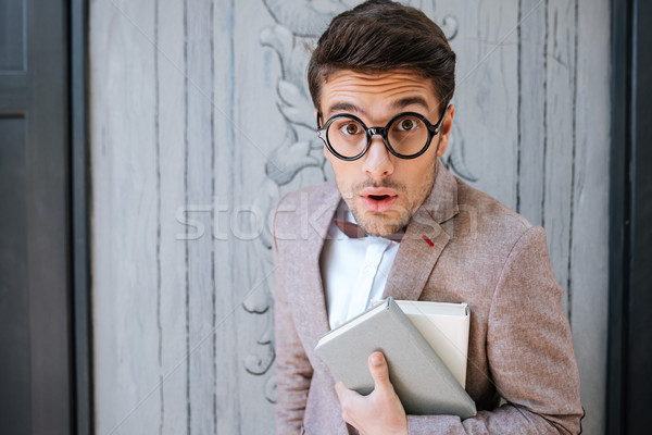 Close-up portrait of a funny nerd man wearing eyeglasses Stock photo © deandrobot