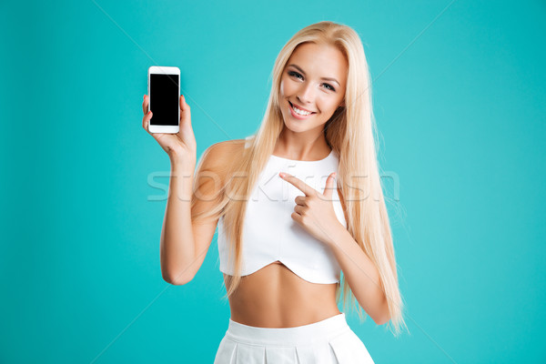 Foto stock: Sorridente · mulher · jovem · indicação · dedo · tela