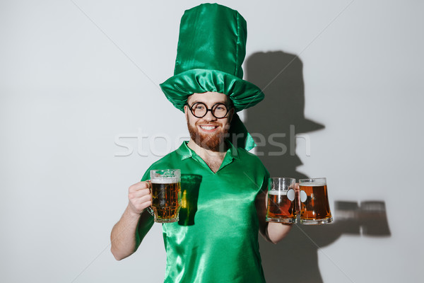 Stock photo: Smiling man in st.patriks costume holding cups