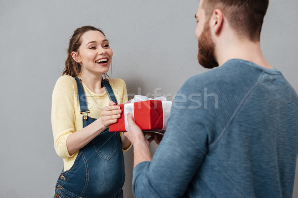Young pregnant woman accepting present from her husband Stock photo © deandrobot