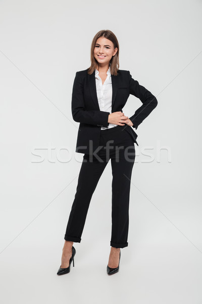 Stock photo: Full length portrait of successful pretty businesswoman in suit