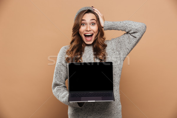 Close-up photo of young overjoyed brunette woman in warm clothes Stock photo © deandrobot