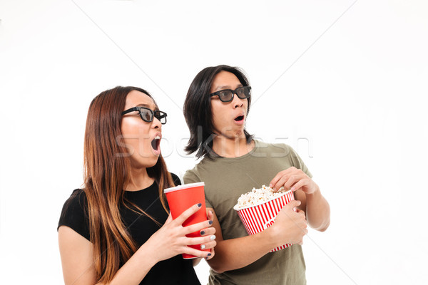 Portrait of a shocked excited asian couple in 3d glasses Stock photo © deandrobot