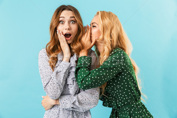 Blonde woman in dress talking something to ear Stock photo © deandrobot