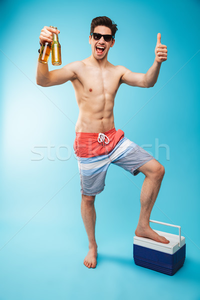 Full length portrait if a cheerful shirtless man Stock photo © deandrobot