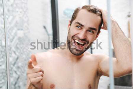 Close up beauty portrait of half naked smiling young man Stock photo © deandrobot