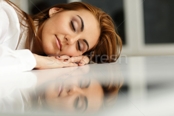 Young businesswoman fallen asleep at office table Stock photo © deandrobot