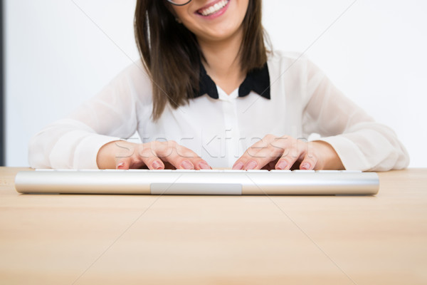 Closeup image of a female hands using keyboard Stock photo © deandrobot