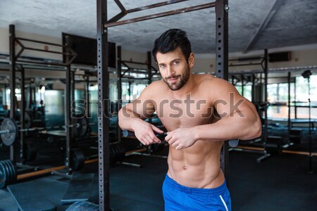 Young muscular man workout on bars Stock photo © deandrobot