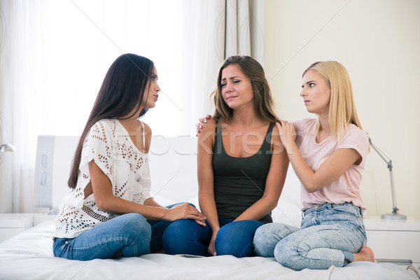 Two teenage girls comforting another Stock photo © deandrobot