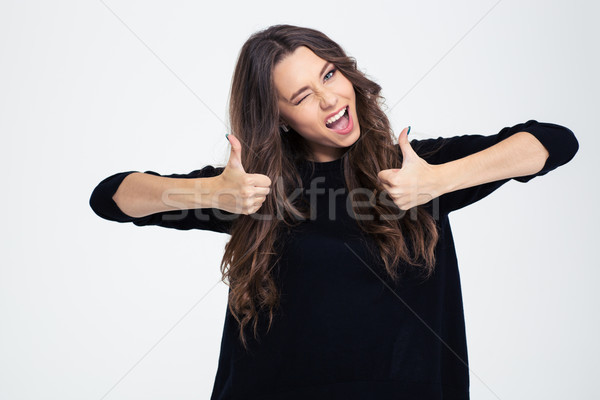 Cheerful woman winking and showing thumbs up  Stock photo © deandrobot