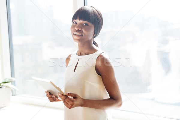 Businesswoman holding tablet compute Stock photo © deandrobot