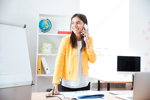 Businesswoman talking on the phone in office Stock photo © deandrobot