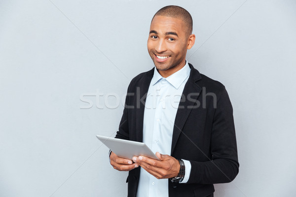 Gelukkig afro-amerikaanse jonge man glimlachend tablet business Stockfoto © deandrobot