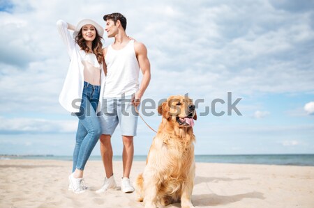 Perro sesión Pareja pie playa feliz Foto stock © deandrobot