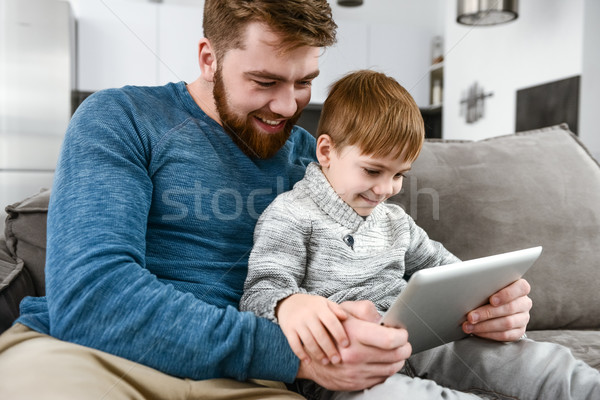 Cheerful family using tablet computer indoors Stock photo © deandrobot