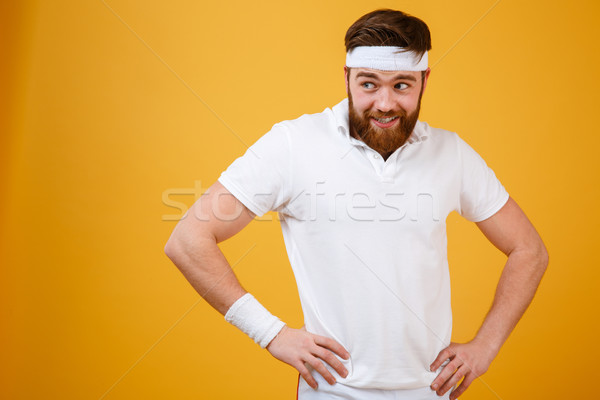 Funny bearded sportsman holding arms at hip Stock photo © deandrobot